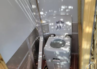 custom fitted bathroom with compostable toilet on our Alabama Tiki Pontoon in Orange Beach