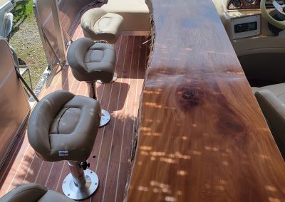 custom solid wood bar with stool on our Alabama Tiki Pontoon boat in Orange Beach